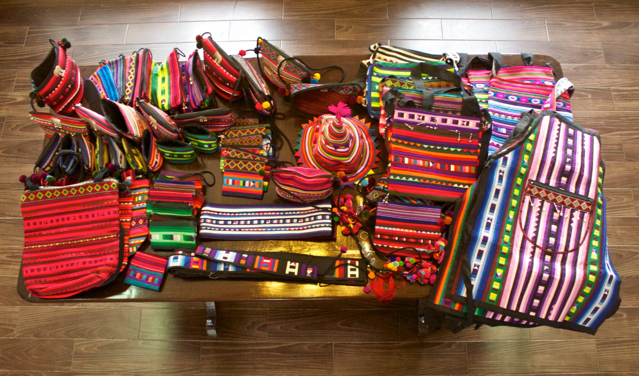 Colourful Lisu handcrafted bags laid out on a table