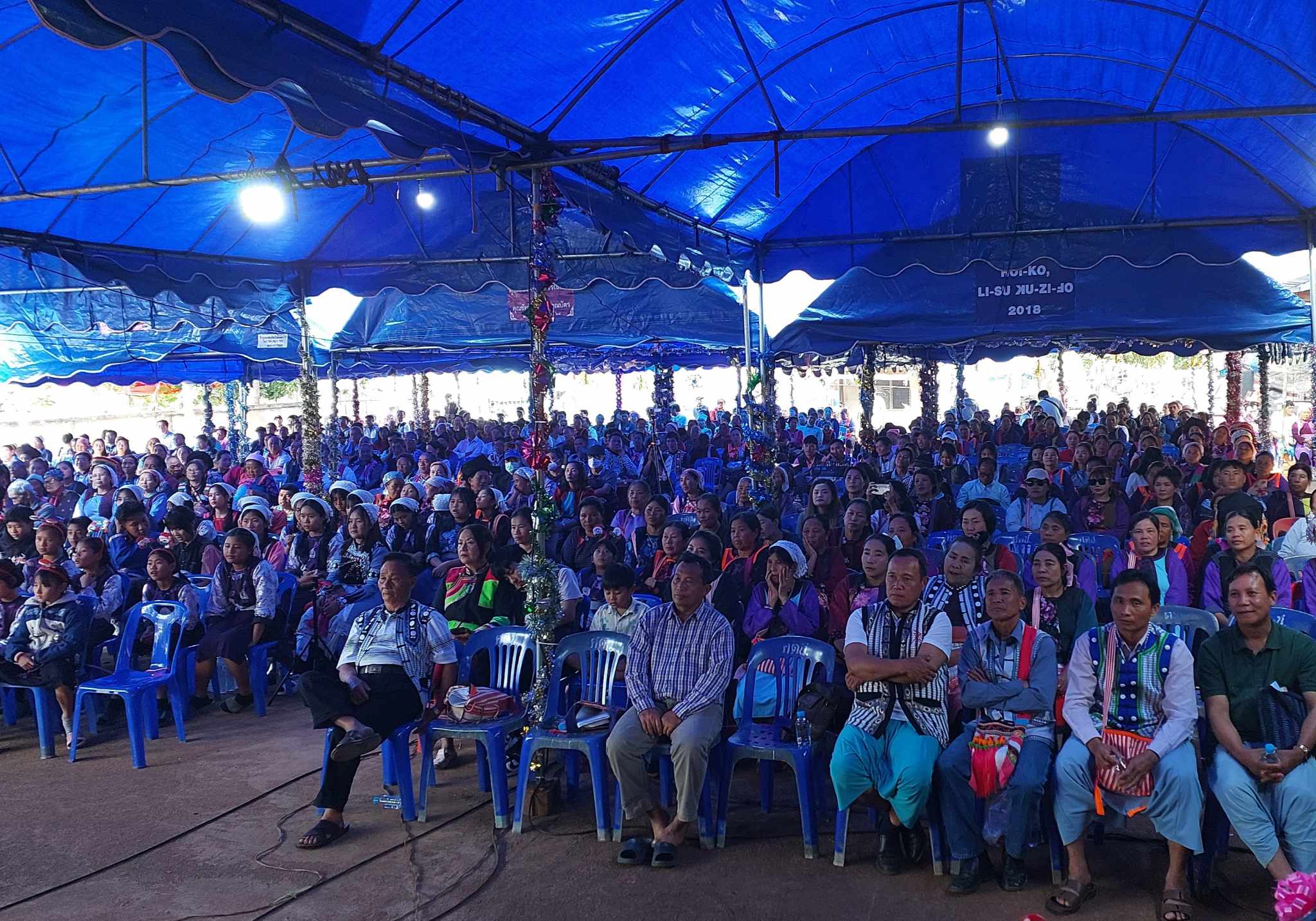 A Christmas conference in Chiang Dao, Thailand, with rows of people seated under a large tent